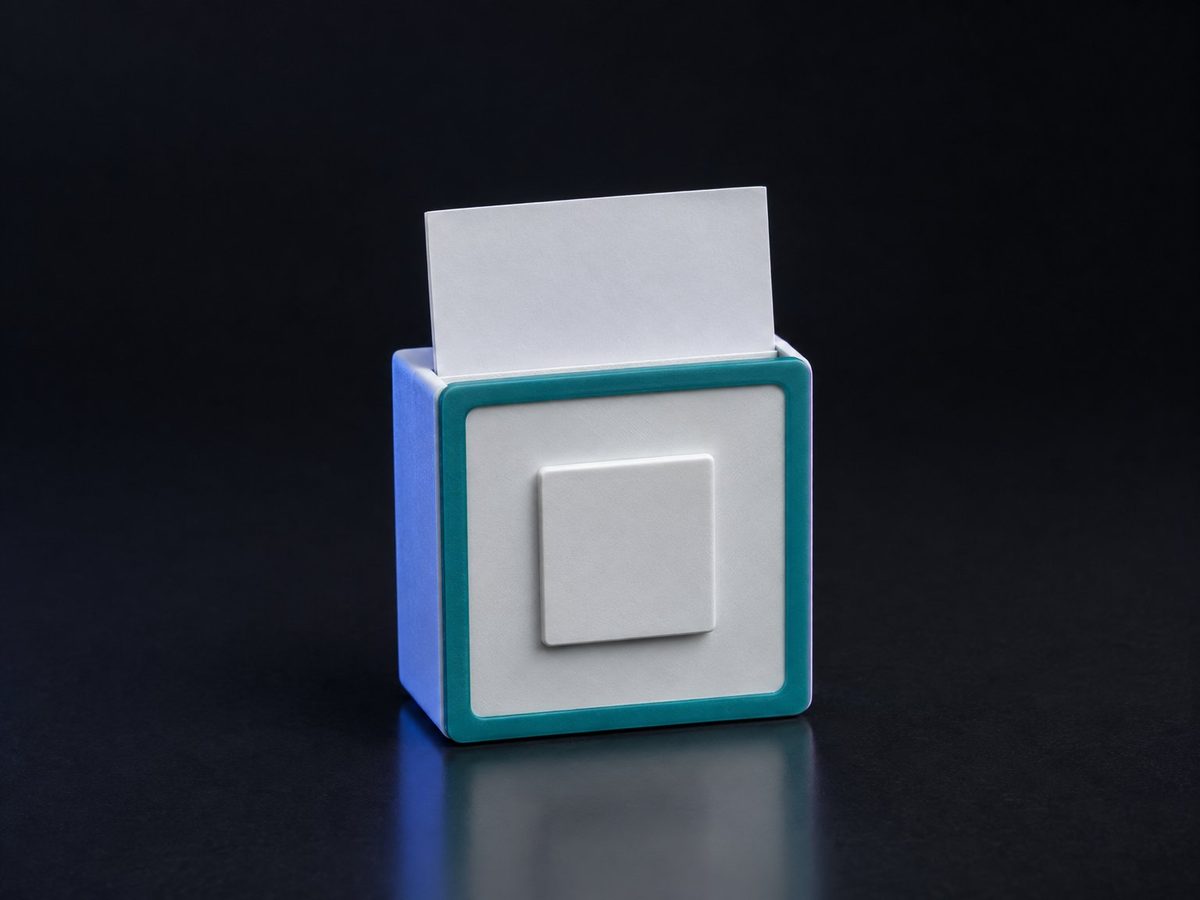 Concept render of a white desk card holder shaped like a periodic-table element tile, with a teal border and a blank raised square in the centre, a blank business card standing in the slot on top