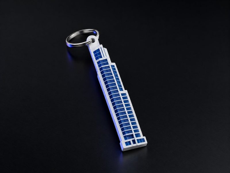 Concept render: Tower keyring. The project's tower in profile, the name on the front, the RERA number on the back.