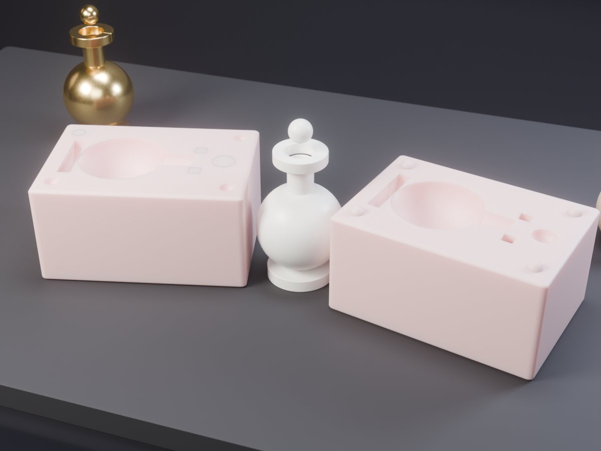 Concept render of a two-part pink silicone mould opened on a dark slate bench, hemispherical cavities facing up, with a white cast kalash-style finial standing between the halves
